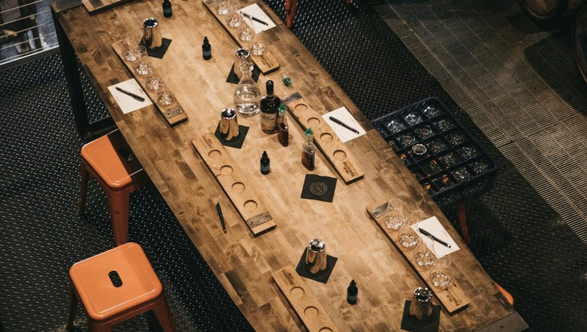 a wooden table topped with lots of bottles of wine