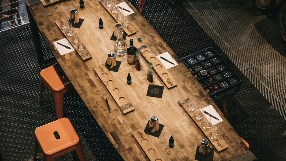 a wooden table topped with lots of bottles of wine
