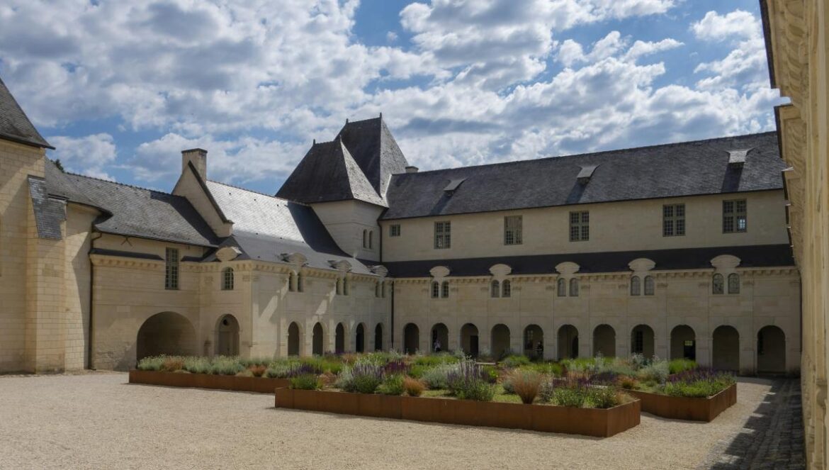 a large building with a lot of plants in front of it