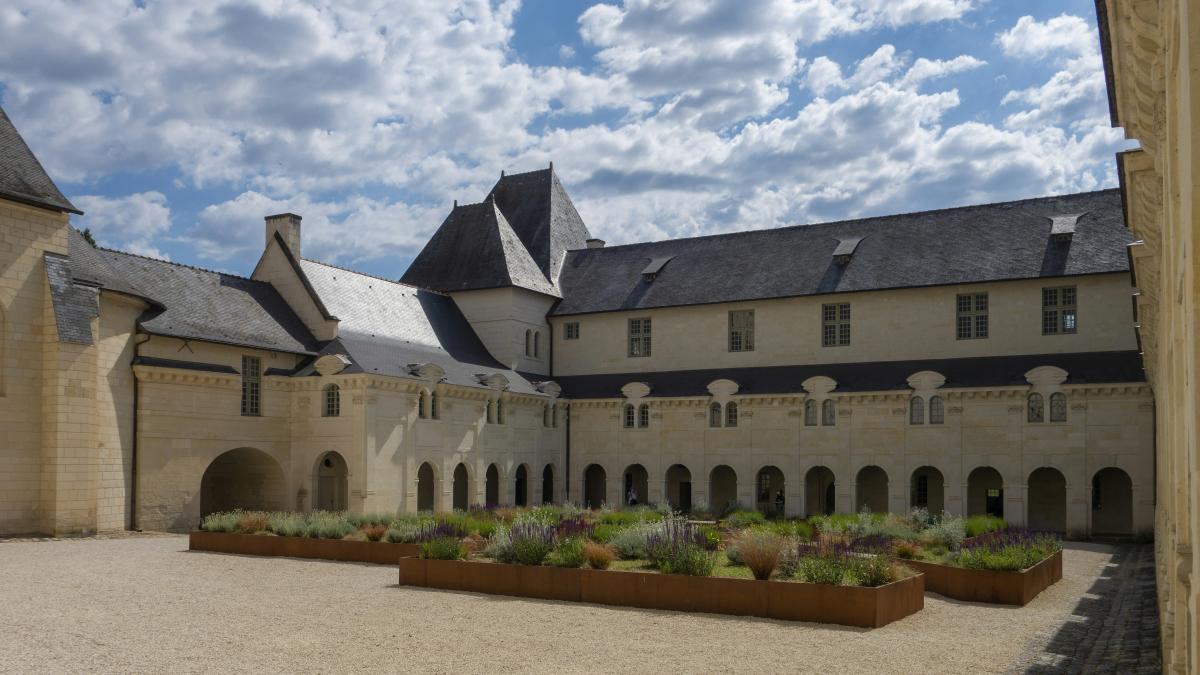 a large building with a lot of plants in front of it