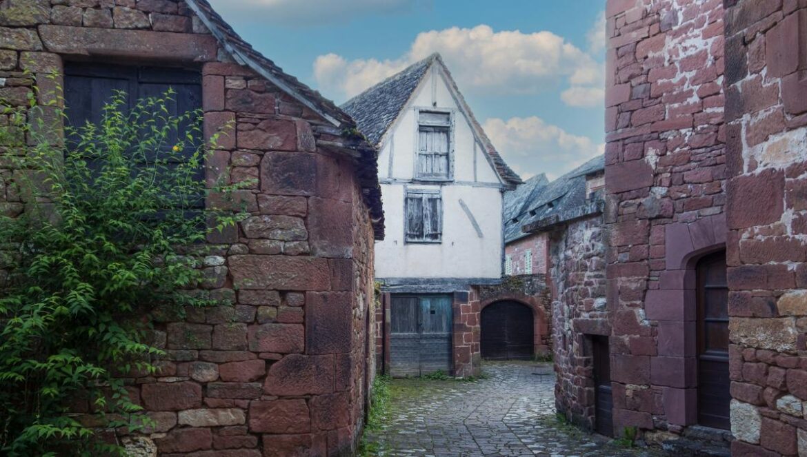 a cobblestone street lined with old brick buildings
