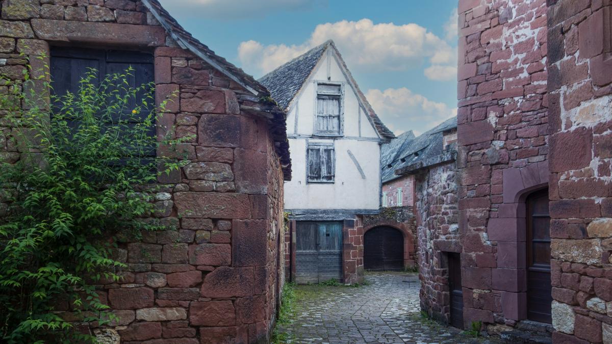 a cobblestone street lined with old brick buildings