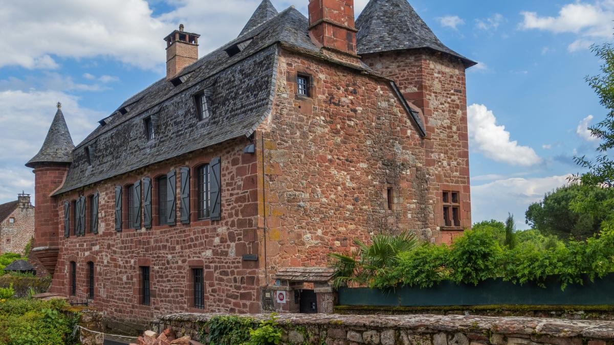 a large brick building with two towers on top of it