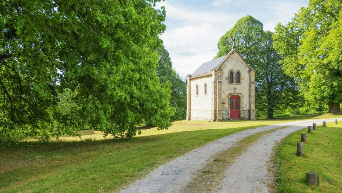 an old church sits in the middle of a field
