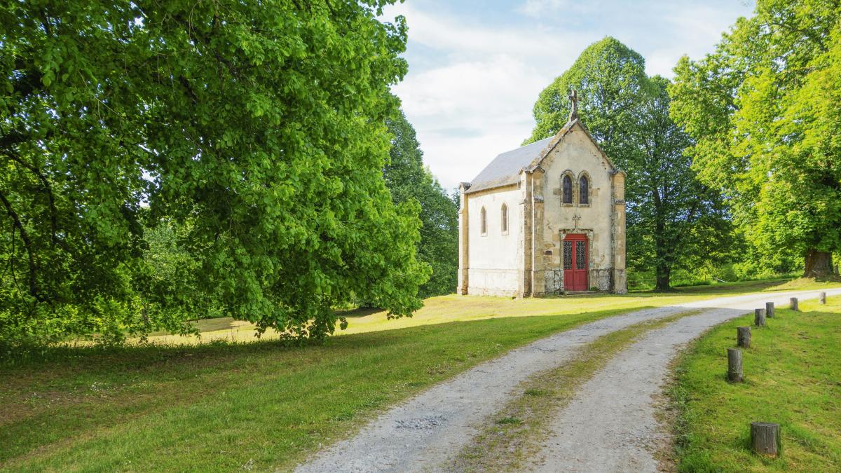 an old church sits in the middle of a field