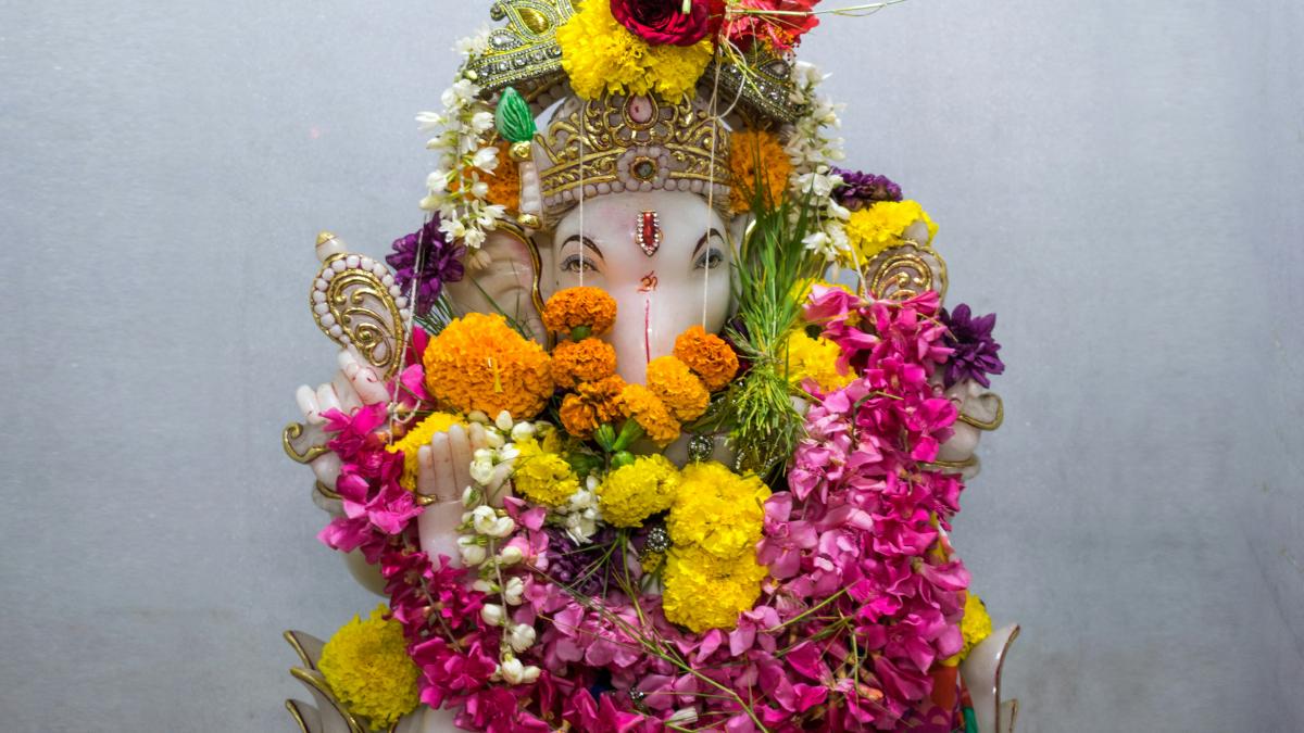 a statue of a person with flowers around it