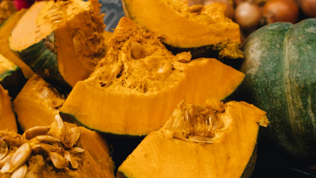 a pile of pumpkins sitting on top of a table