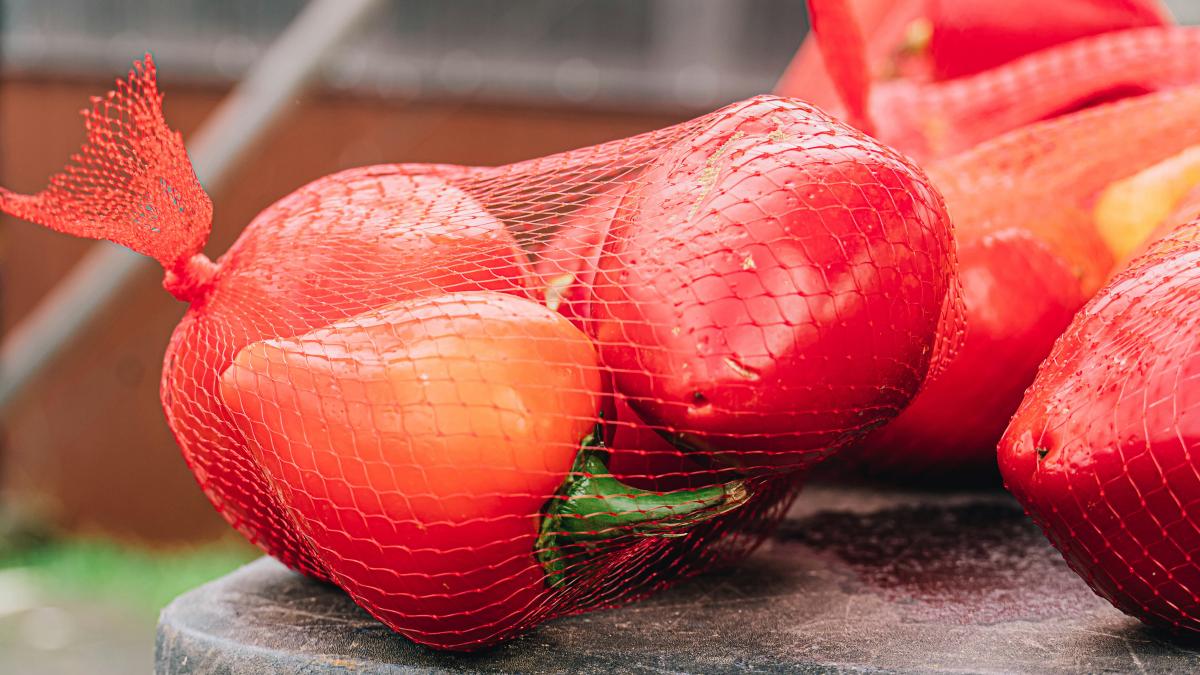 a pile of red fruit sitting on top of a table