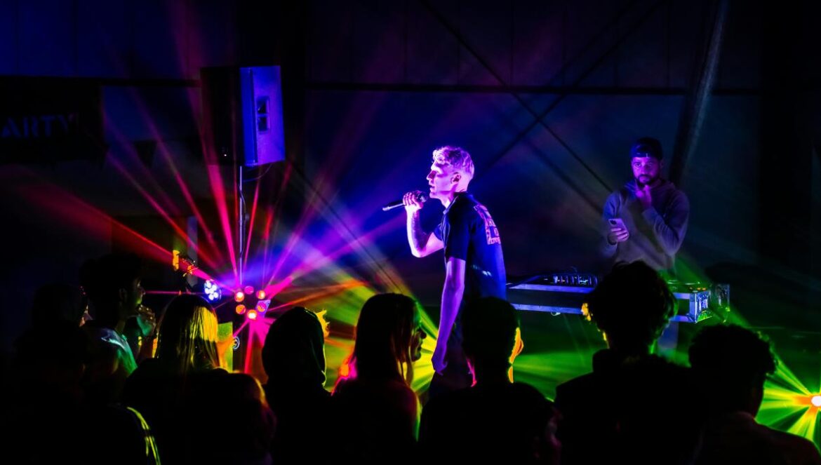 a woman standing on a stage in front of a crowd