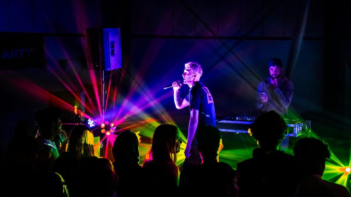 a woman standing on a stage in front of a crowd