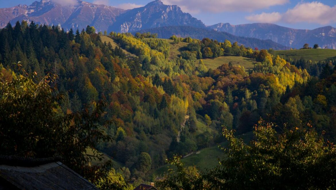 a view of a mountain range with a house in the foreground
