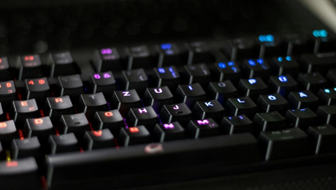 a close up of a black keyboard with red and blue keys