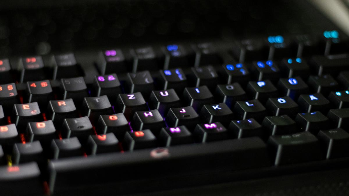 a close up of a black keyboard with red and blue keys