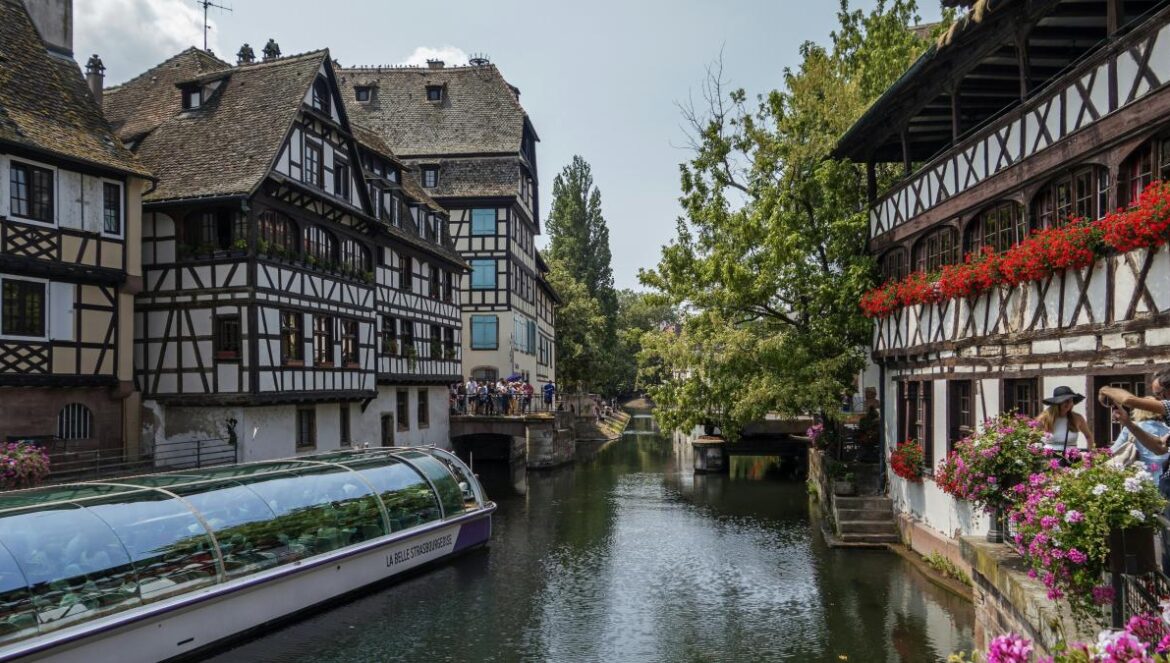 a river running through a city next to tall buildings