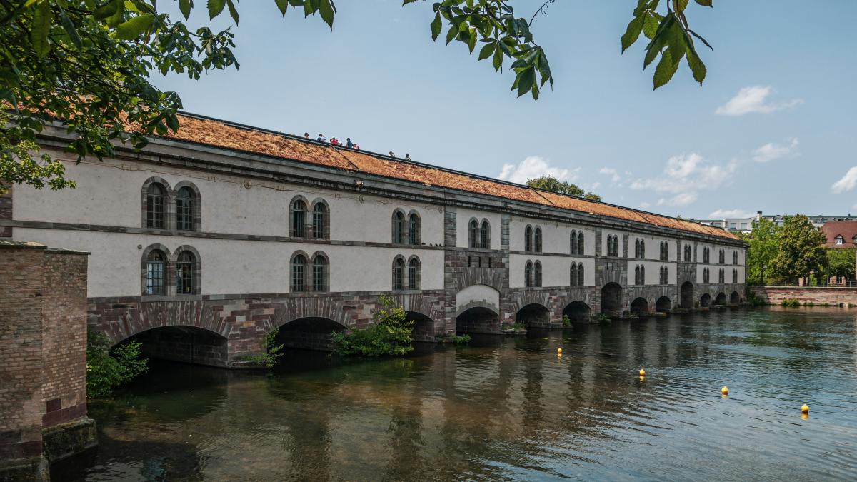 a bridge over a body of water next to a building