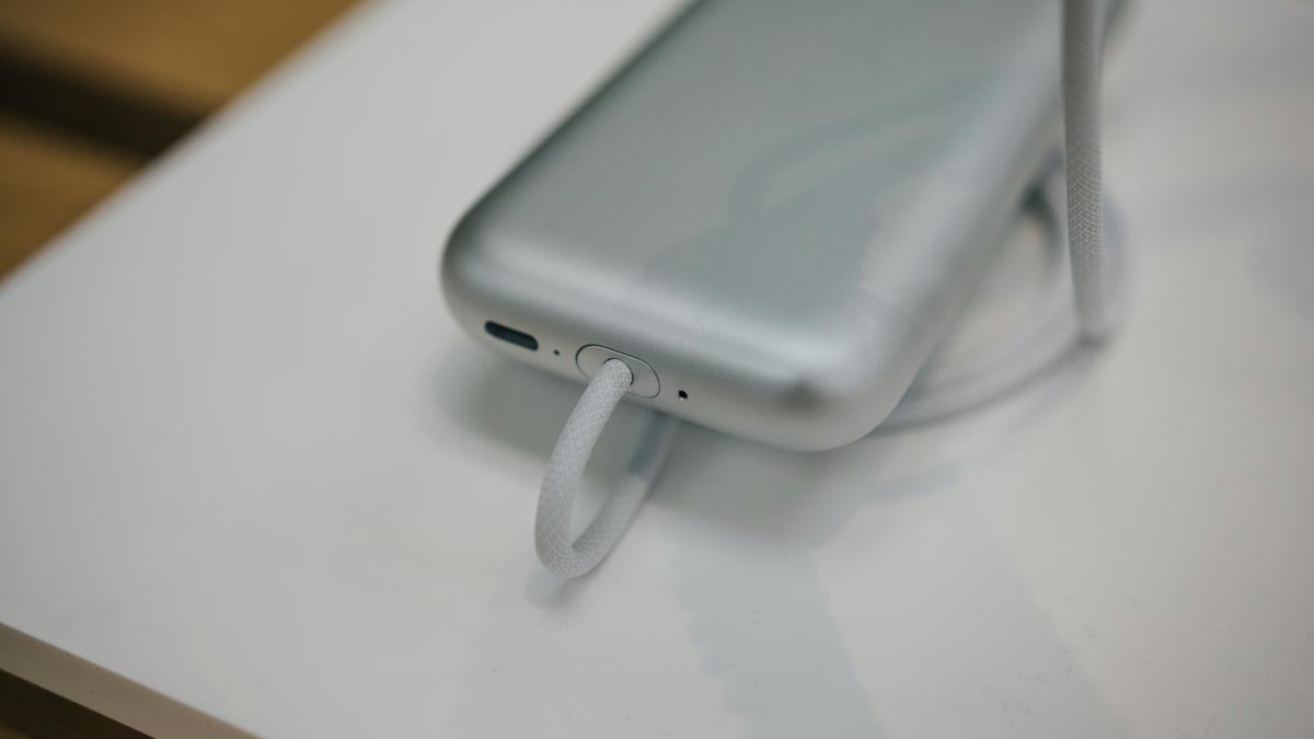 a cell phone plugged into a charger on a table