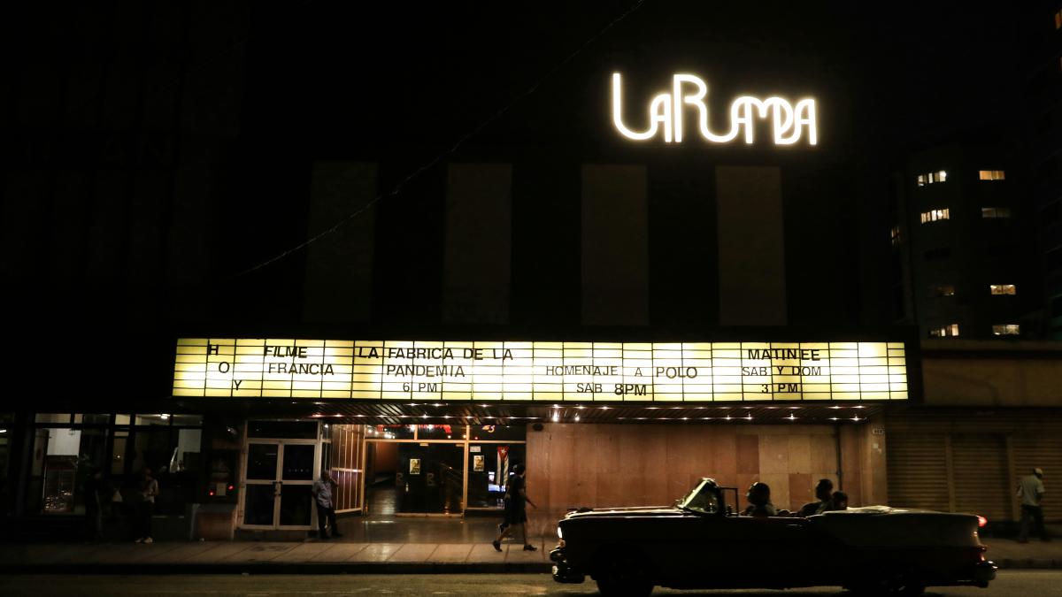 a car parked in front of a theater at night