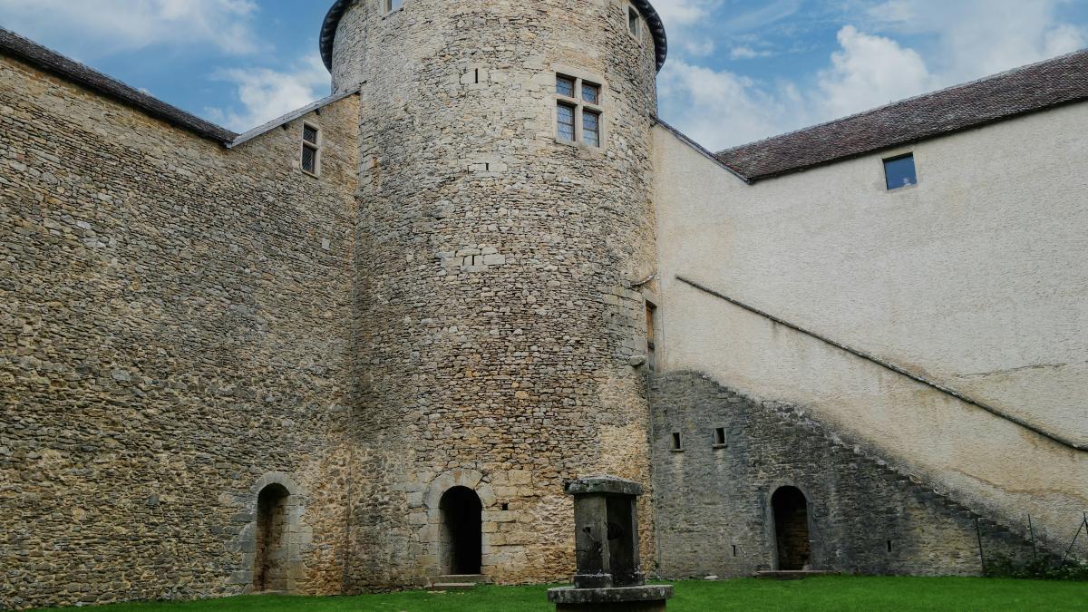 a stone building with a green lawn in front of it