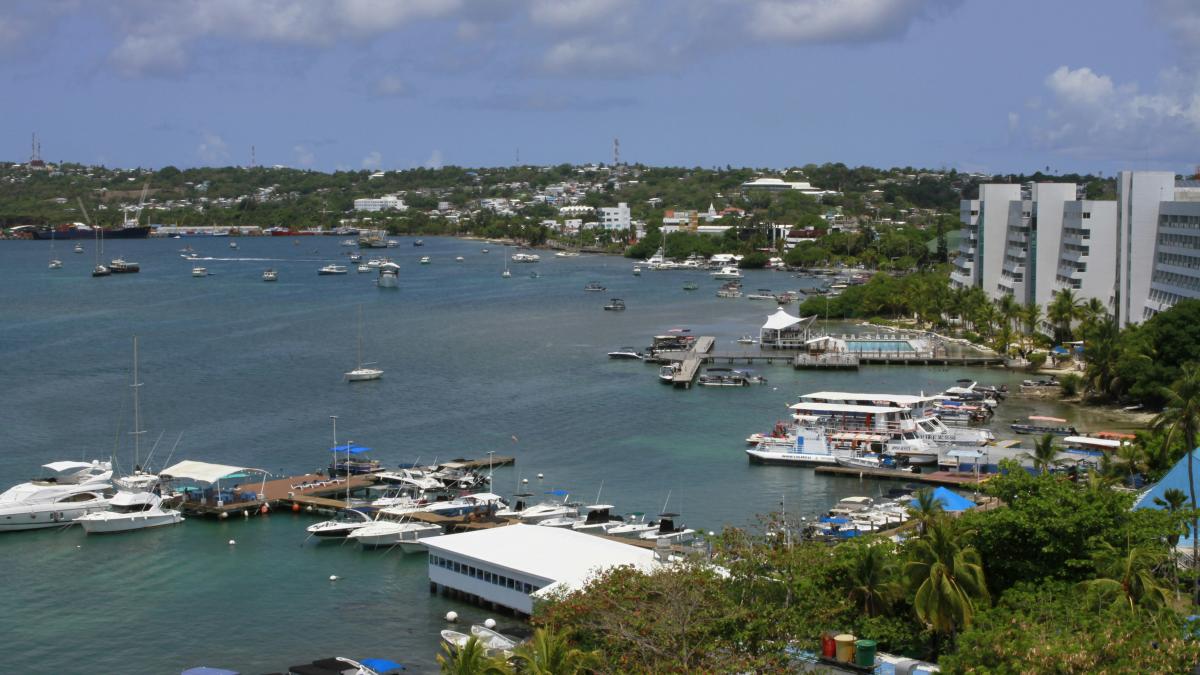 a harbor filled with lots of boats next to tall buildings