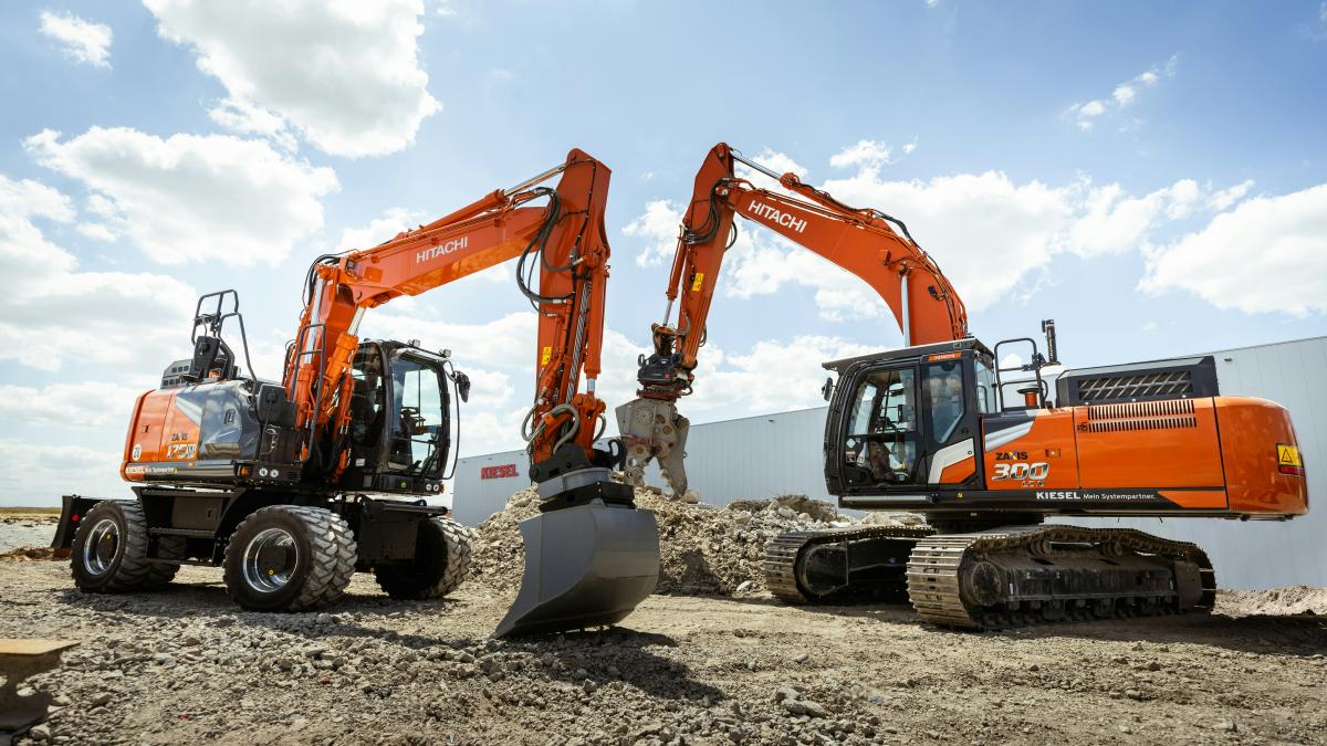 A group of construction equipment sitting on top of a dirt field