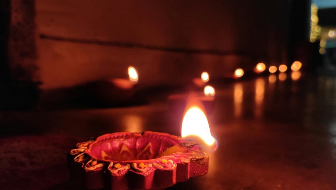 A group of lit candles sitting on top of a table