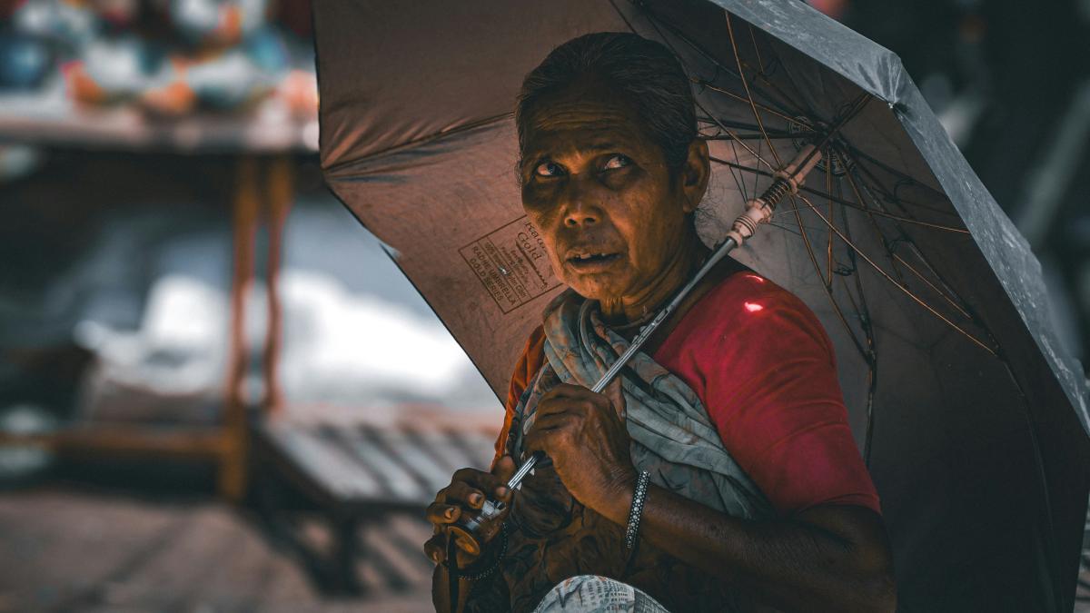A woman holding an umbrella in the rain