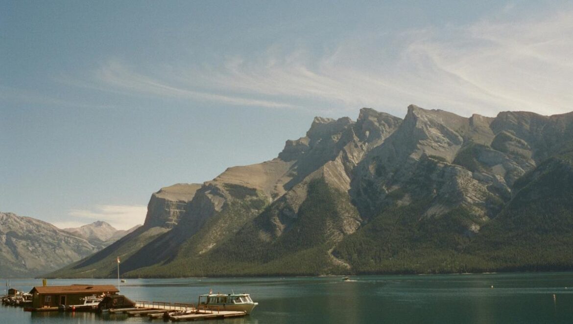 A body of water with a mountain in the background