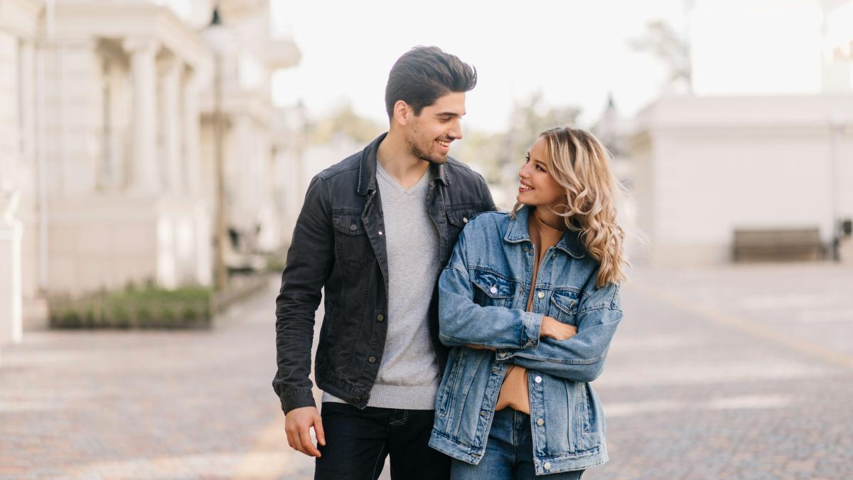 A man and a woman walking down a street