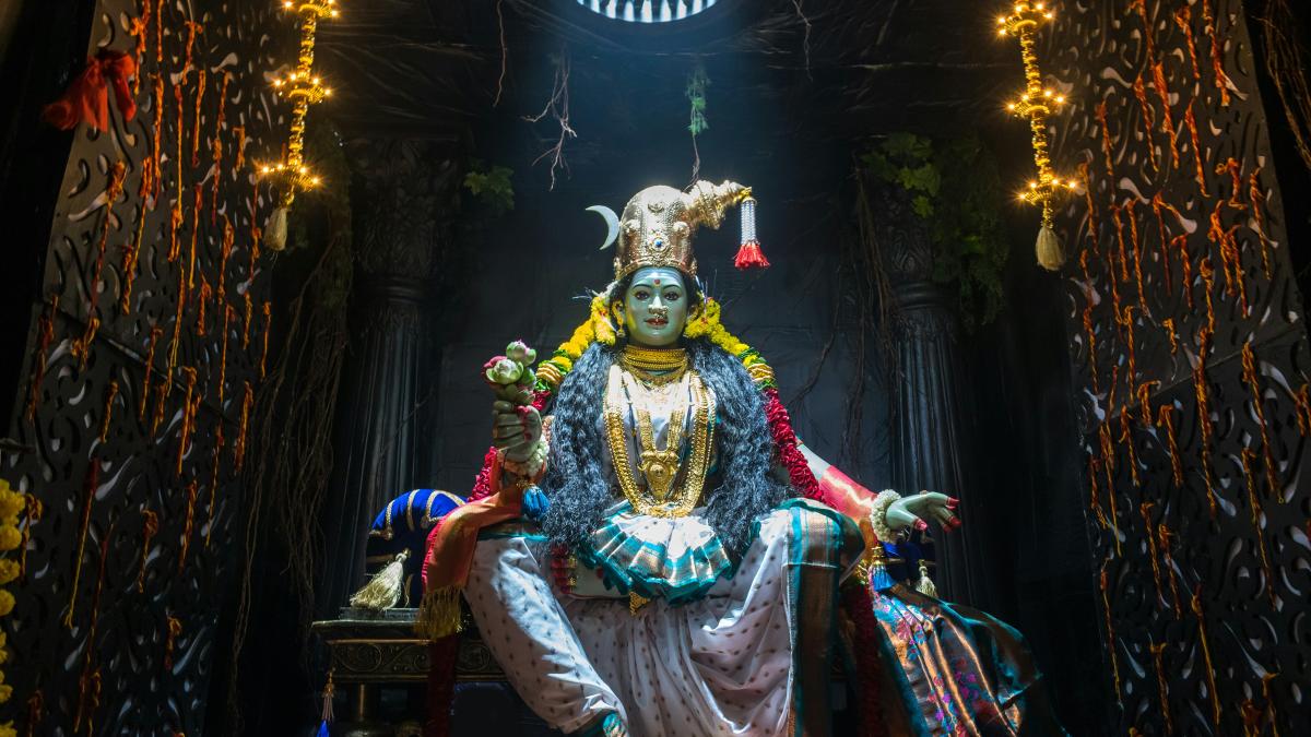 A statue of a person sitting on a bench