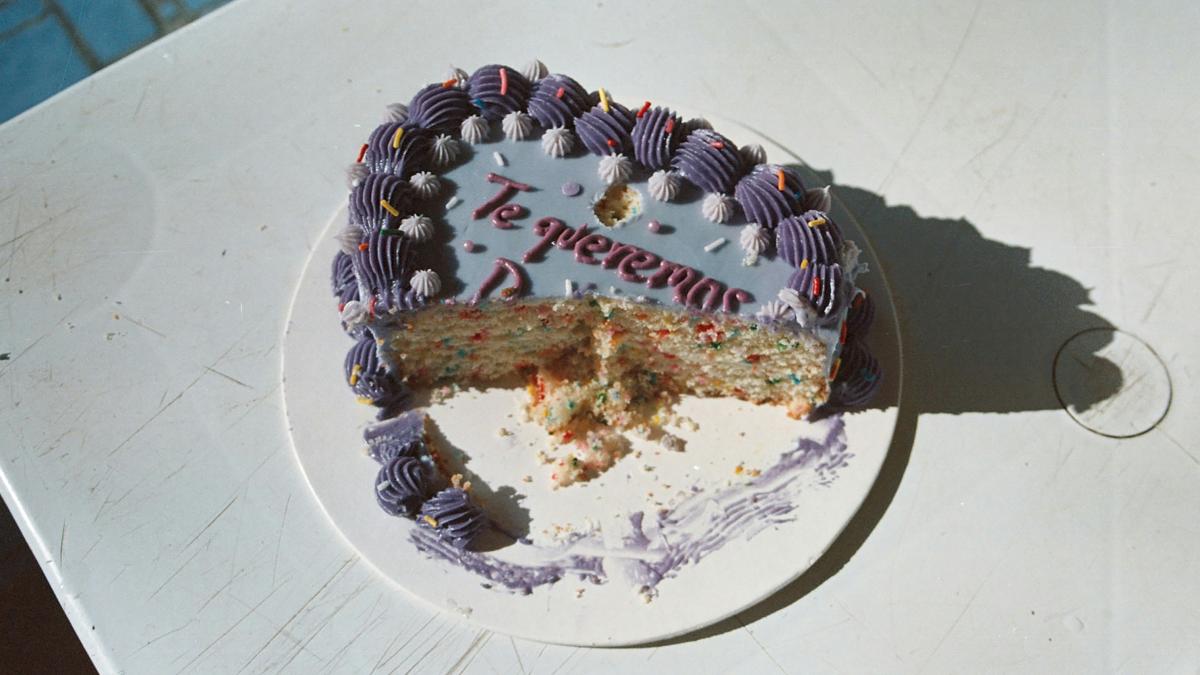 A half eaten cake sitting on top of a table