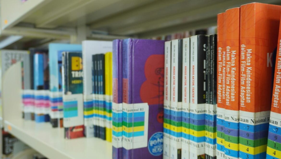 A row of books on a shelf in a library