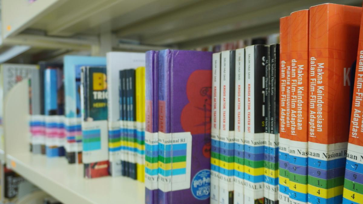 A row of books on a shelf in a library