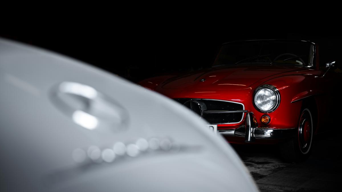 A red car parked in a dark garage