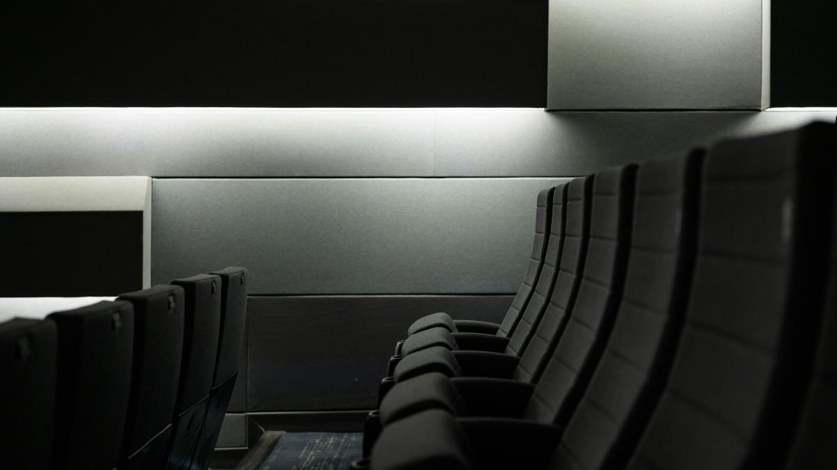 A row of empty seats in a dark room