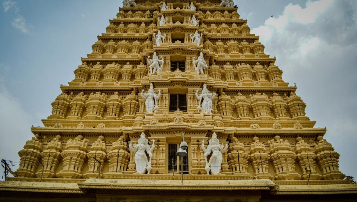 A very tall building with statues on top of it