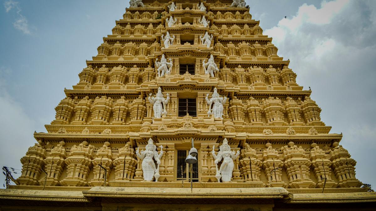 A very tall building with statues on top of it