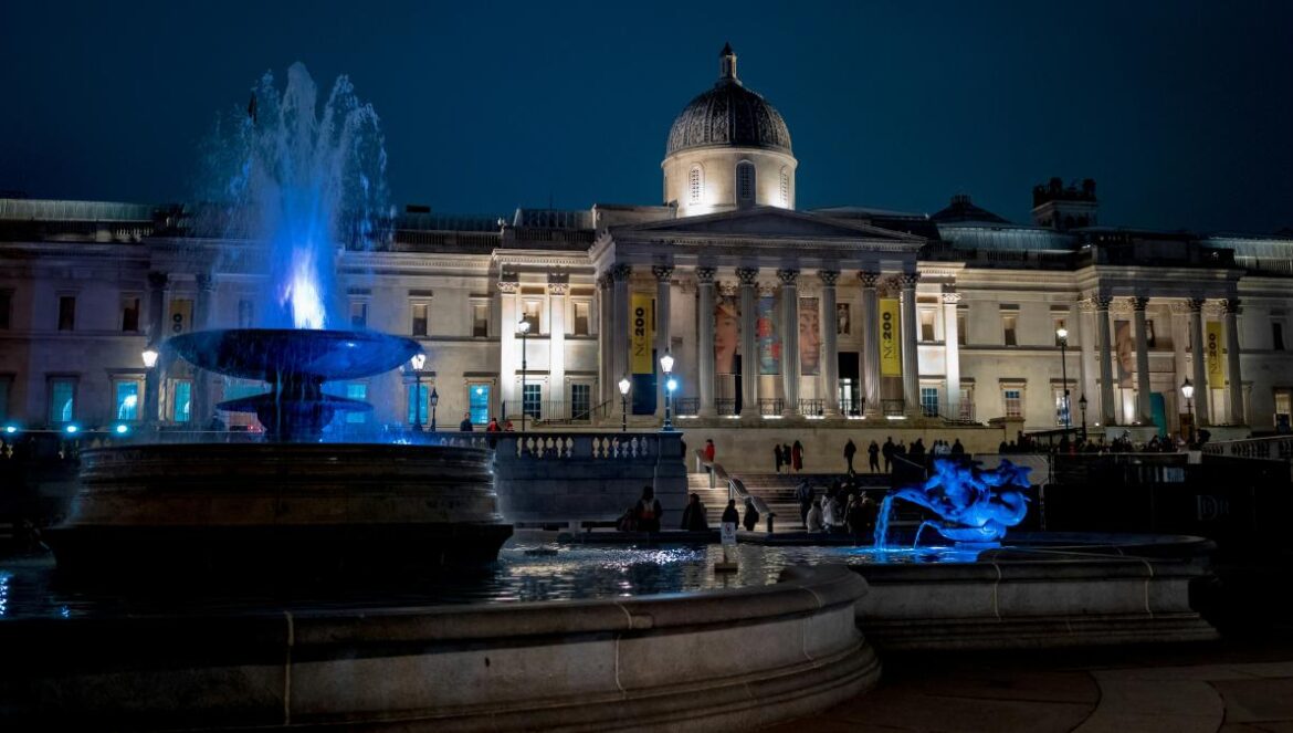 A large building with a fountain in front of it