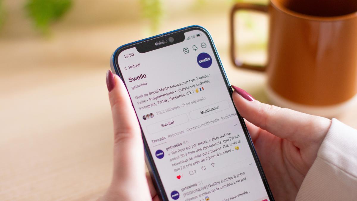 A woman holding a cell phone in her hand