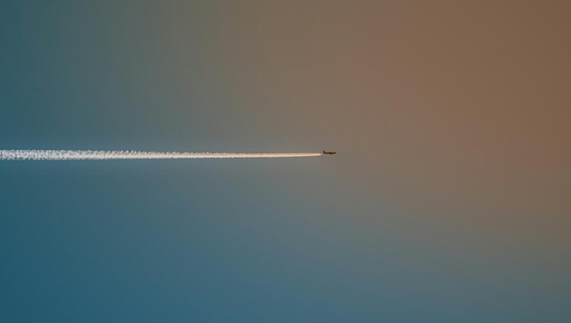 A plane leaves a vapor trail across the sky.