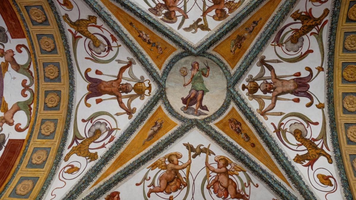 Ceiling frescoes depict mythological figures and angels.
