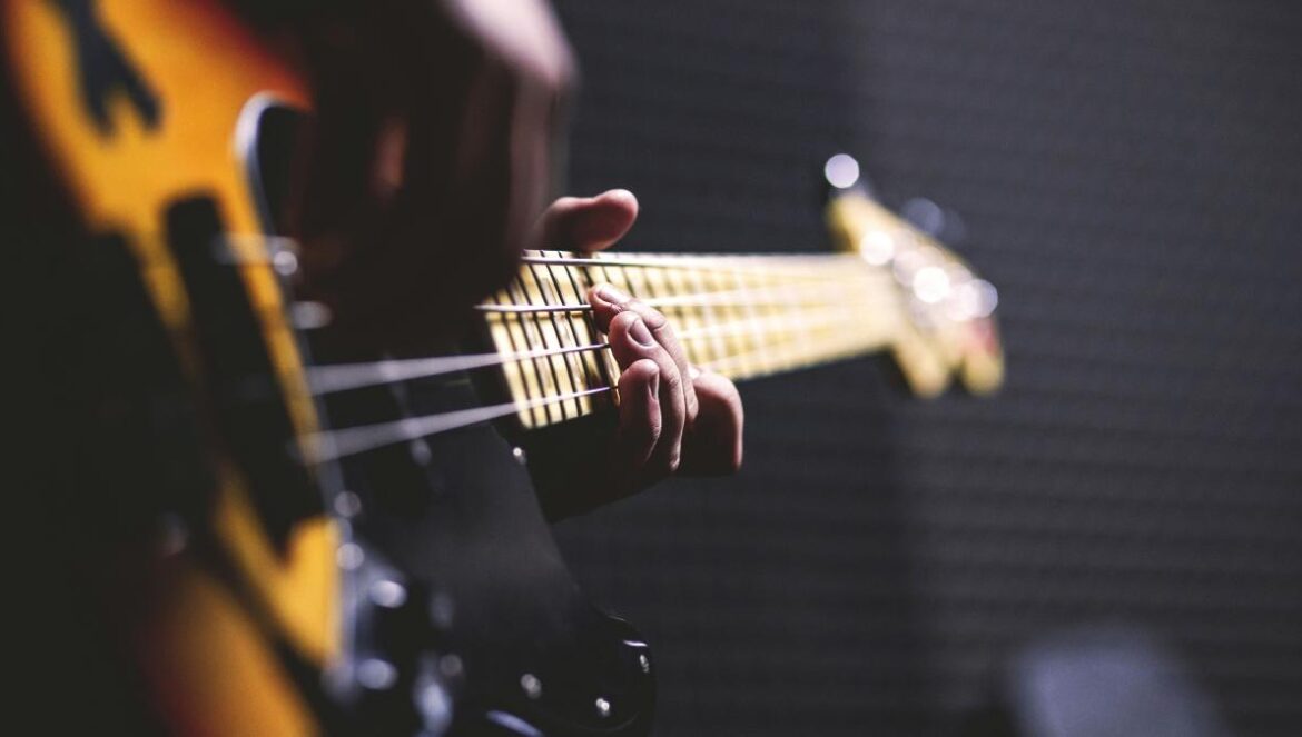closeup photo of person playing bass