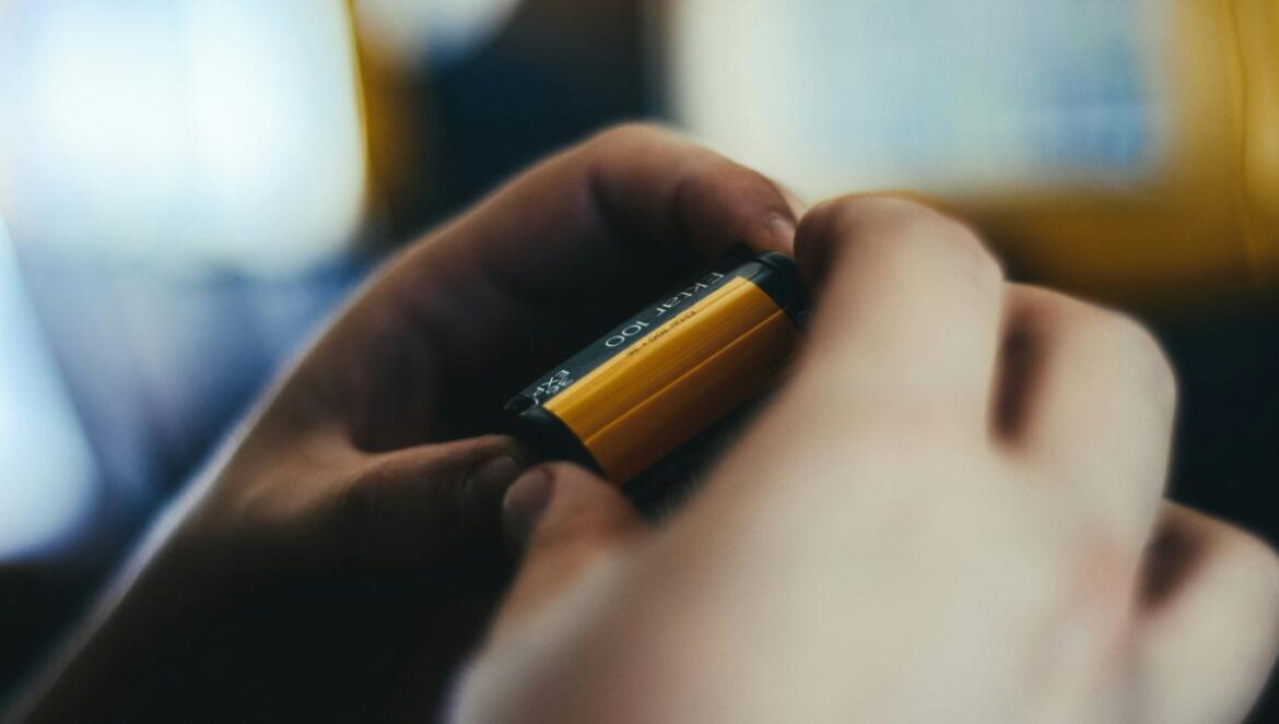 person holding brown and black battery