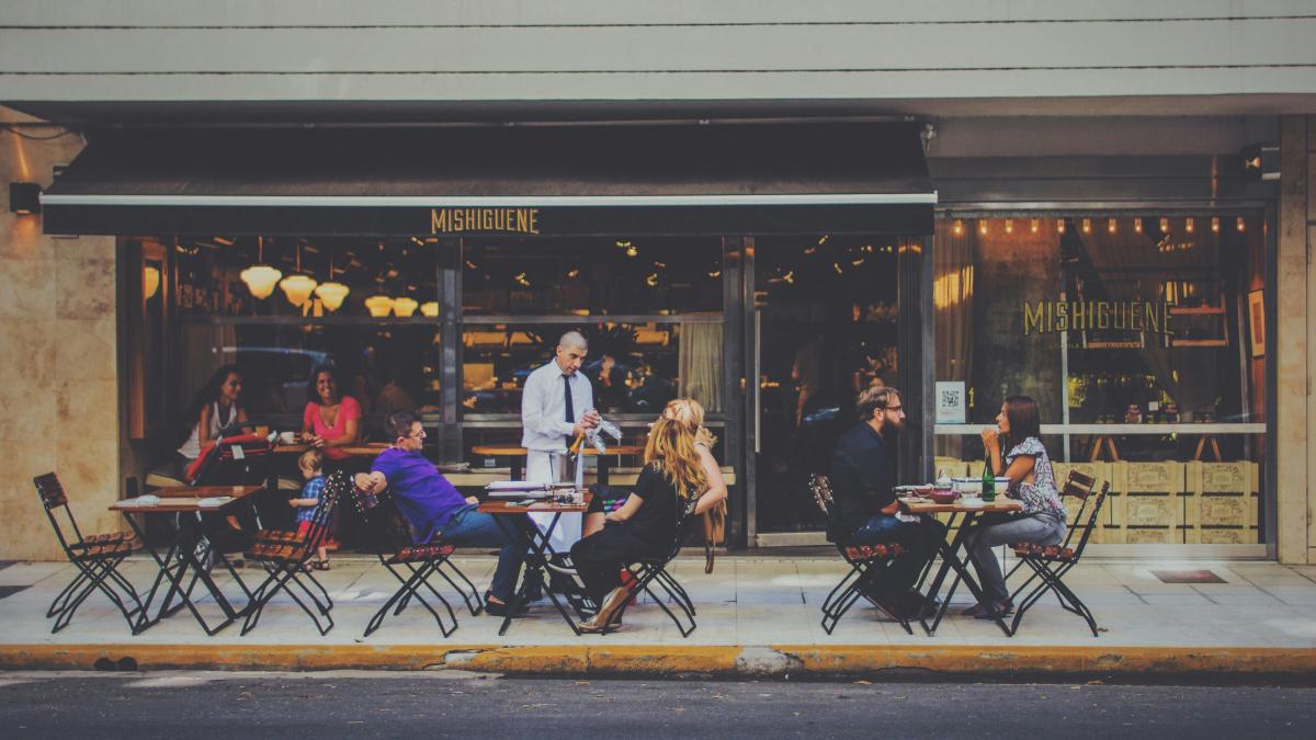 people sitting on chairs in front of facade