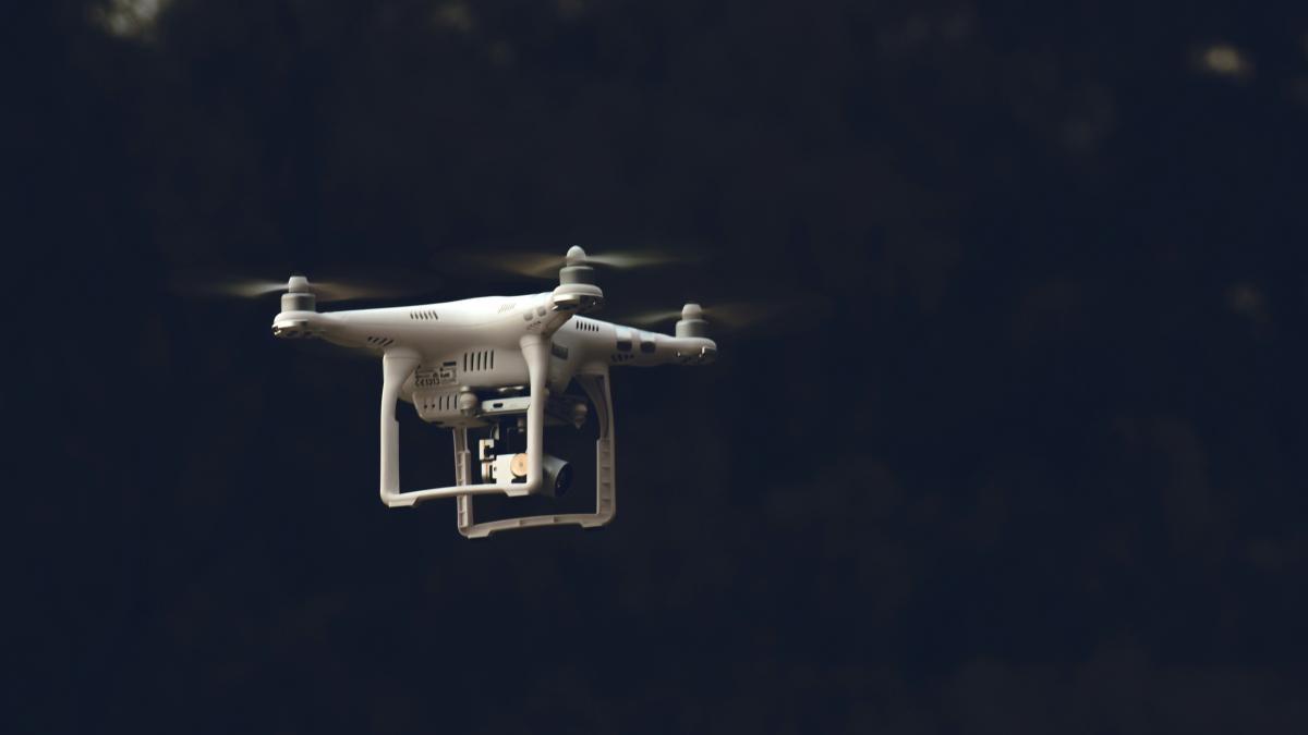 white DJI phantom-series quadcopter flying during daytime