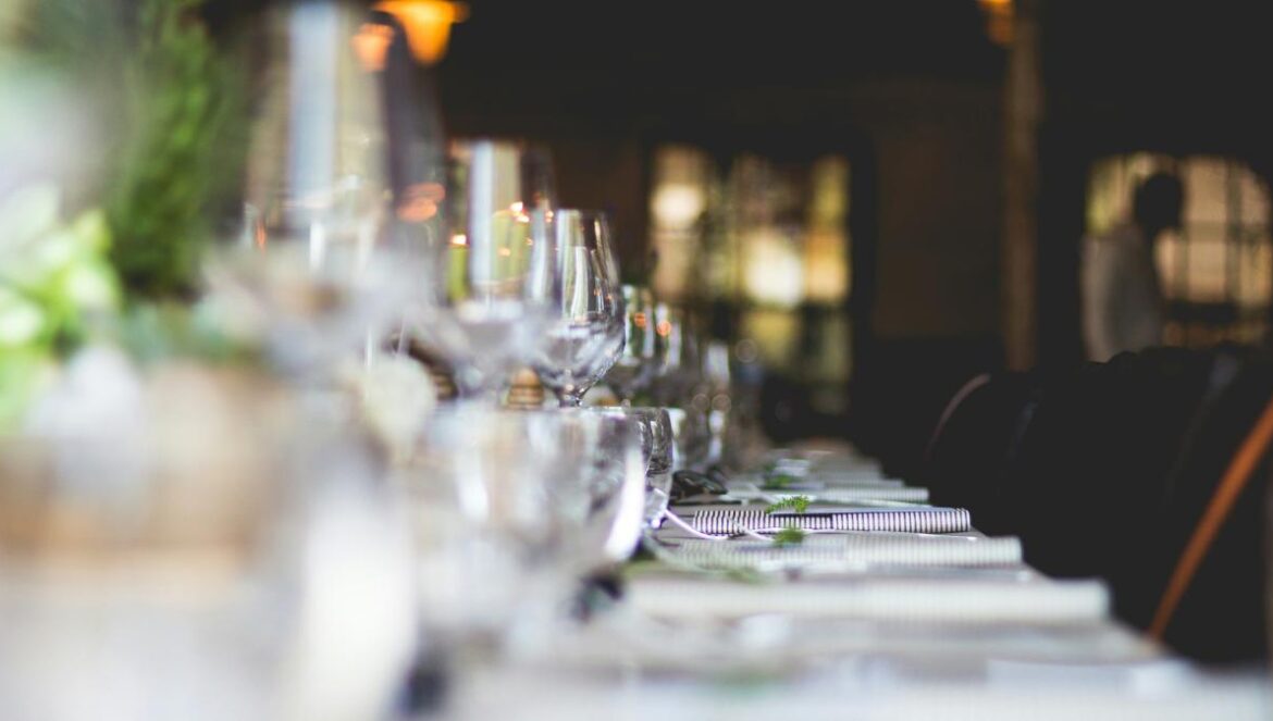 focused photo of wine glasses lined on table