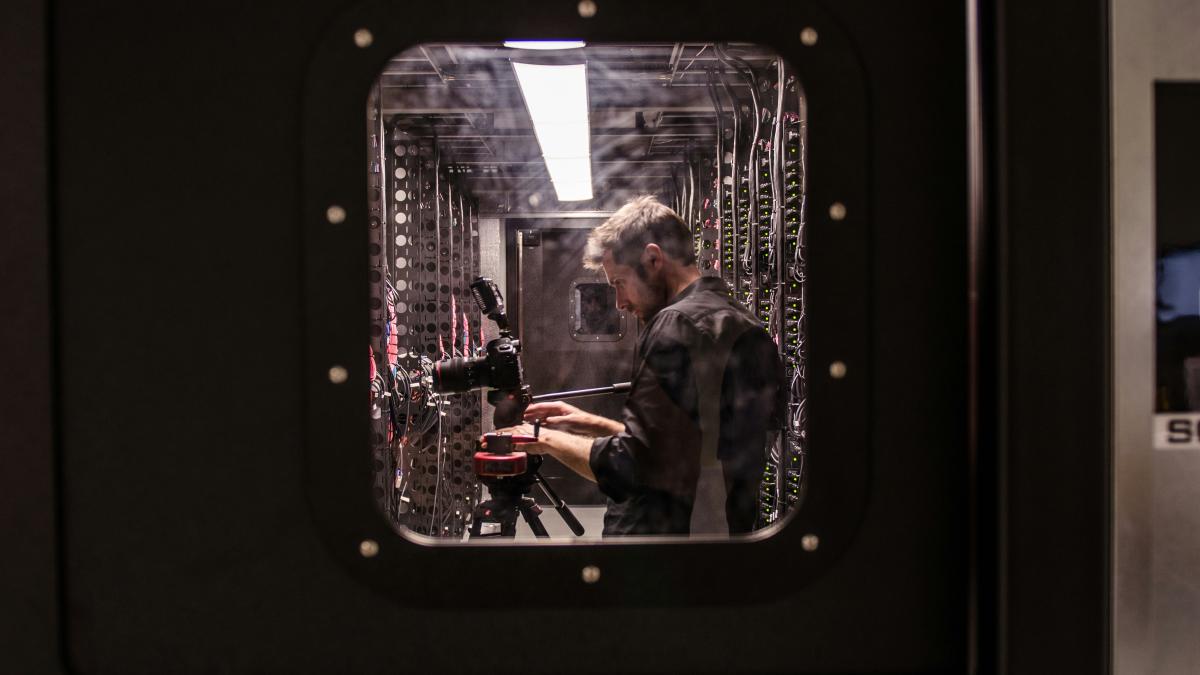 man holding black DSLR camera