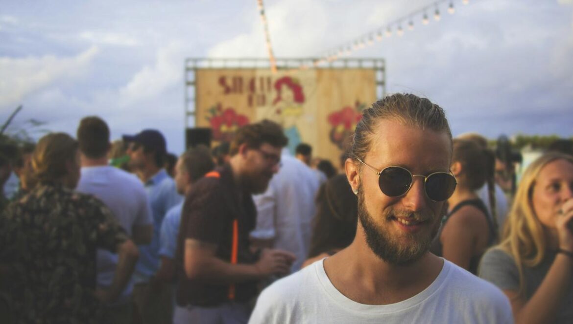 person wearing white crew-neck shirt beside crowd