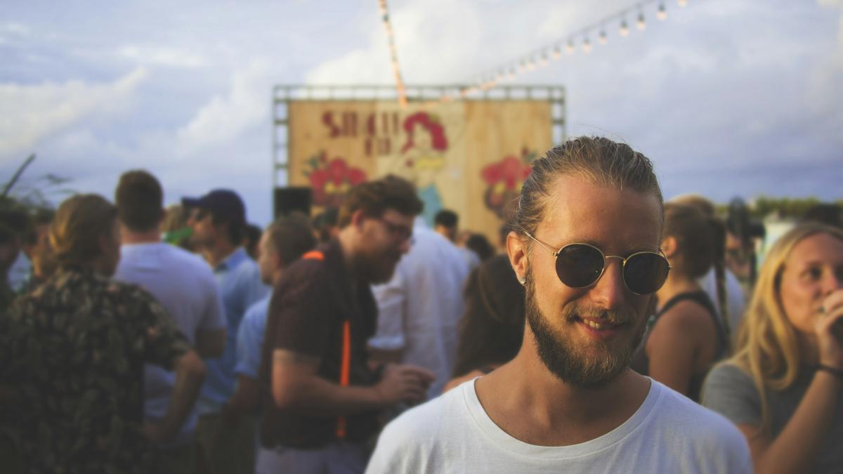 person wearing white crew-neck shirt beside crowd