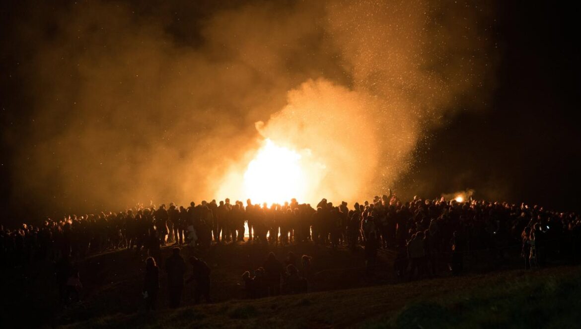 people gathered near bonfire during nighttime