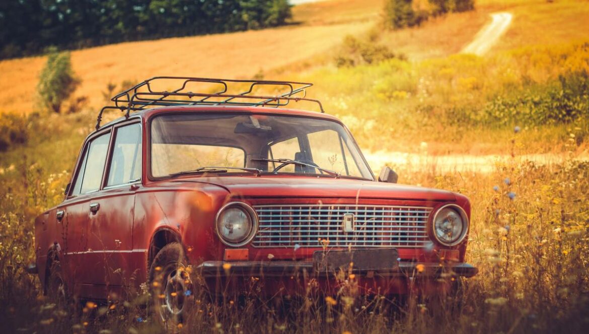classic red car on grass field